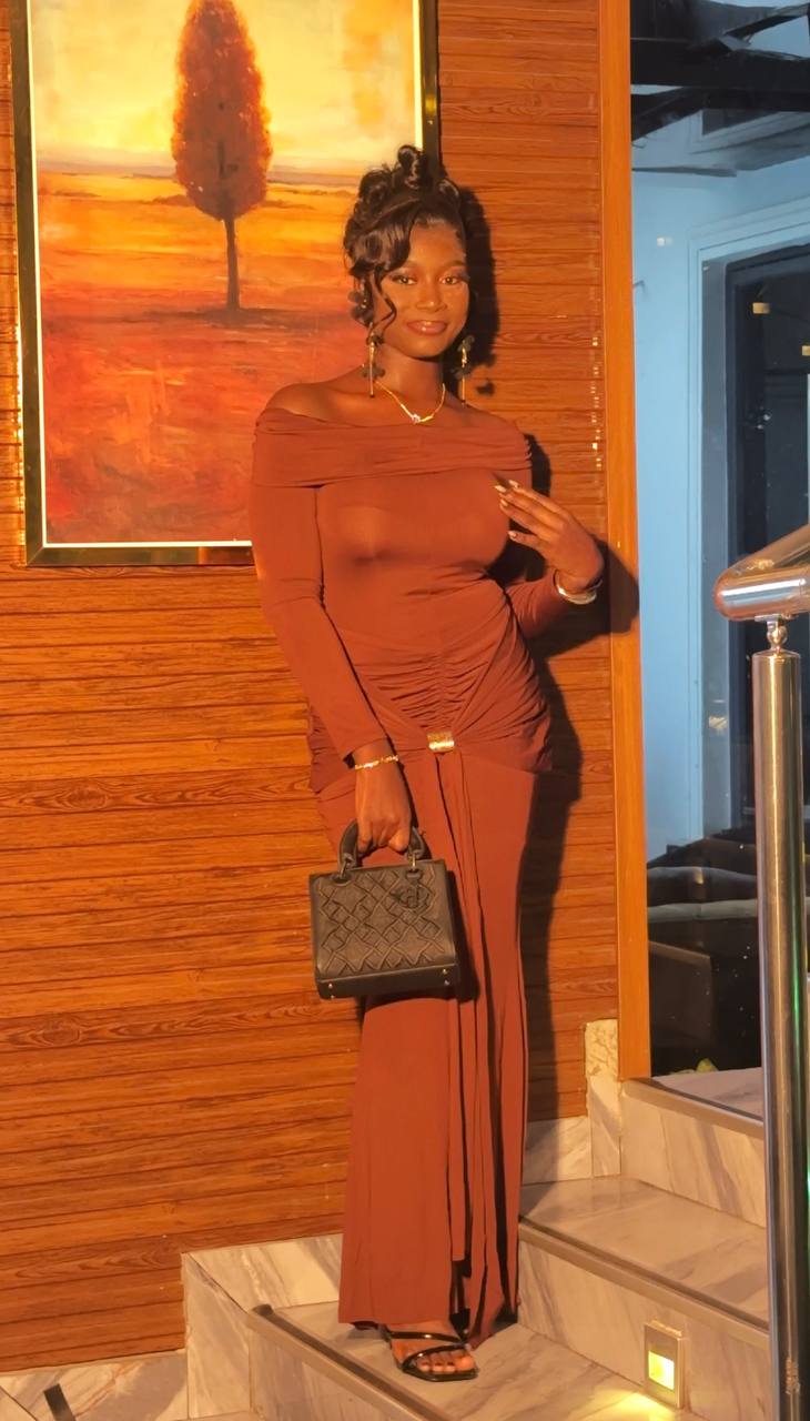 Woman in brown off-shoulder dress with soft glam makeup